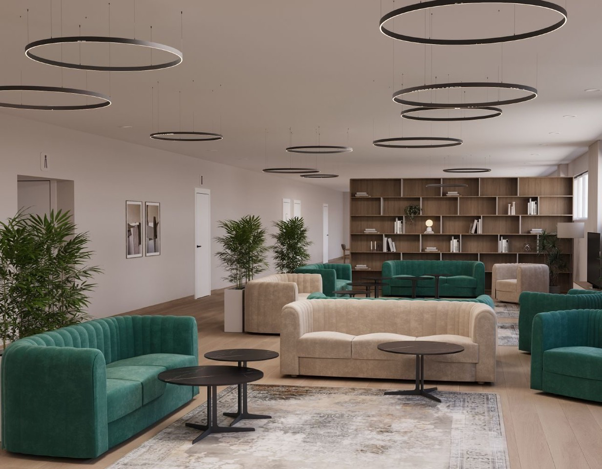 Salon modern de relaxare cu canapele tapițate în verde și bej, mese rotunde negre, plante decorative și bibliotecă din lemn într-un centru de îngrijire pentru seniori