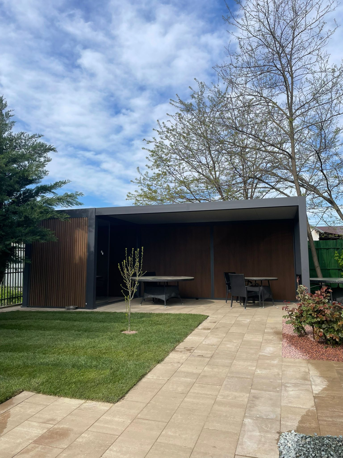 Pavilion modern cu acoperis plat si mobilier de exterior, amenajat pentru relaxare seniori intr-un centru de ingrijire
